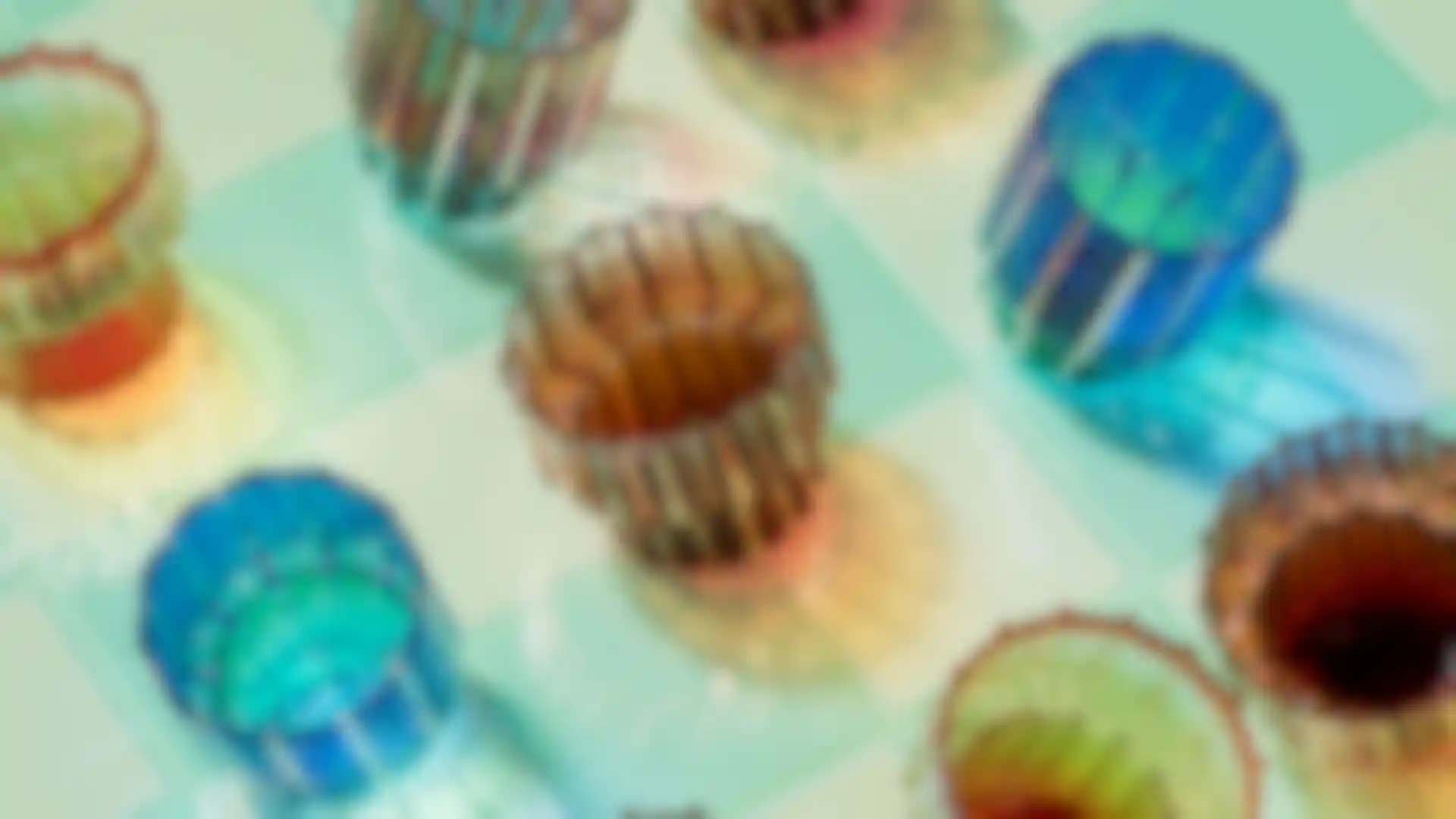 3D rendered colorful glass cups with artistic lighting on reflective tiled surface